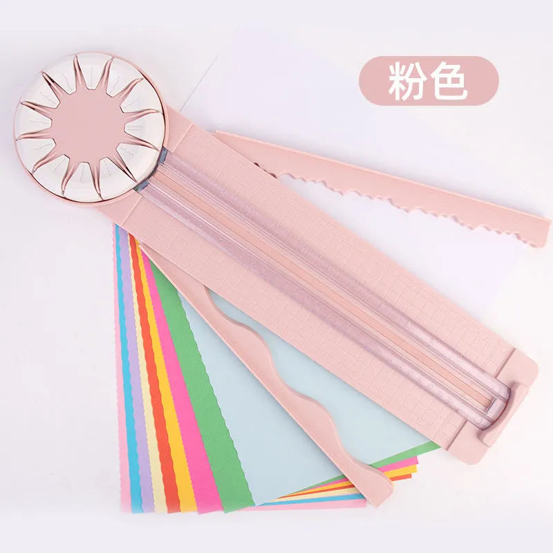 Pink and black 12-in-1 dotted plastic paper cutting machine on a white background.