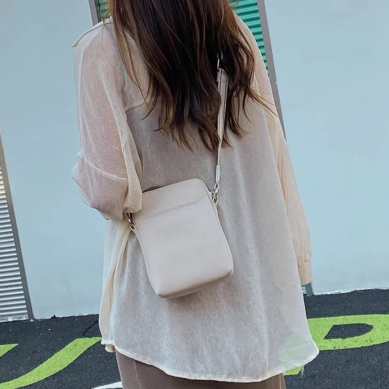 Solid colour PU leather small crossbody phone bag measuring 14.5cm by 5.5cm by 19cm