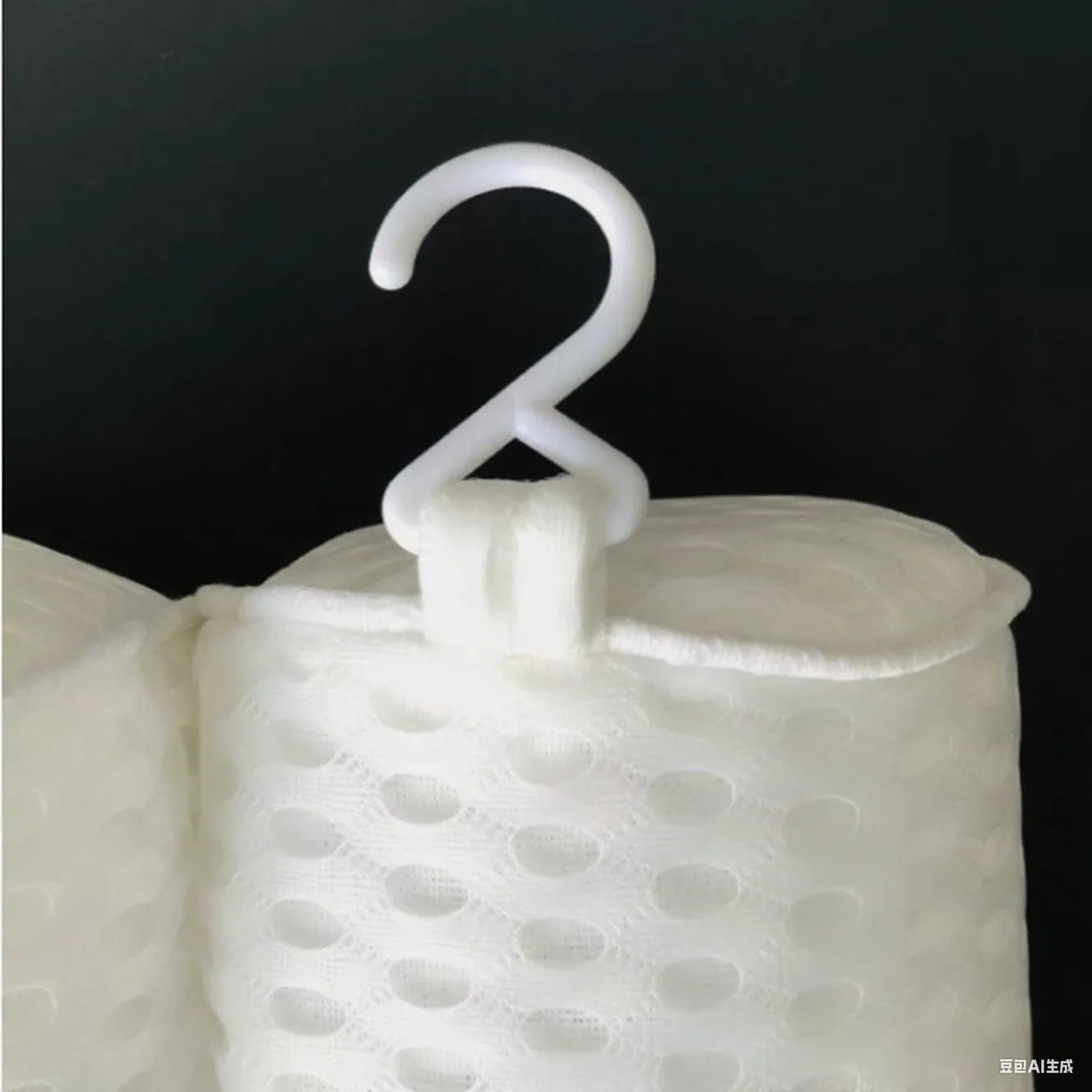 White bathtub pillow with mesh fabric and suction cups on a bathtub edge.