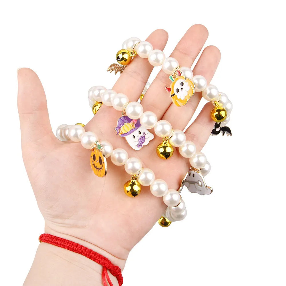 Halloween decorative cat collar with simulated pearl necklace in purple ghost pumpkin, skull pumpkin, and smiling pumpkin patterns.