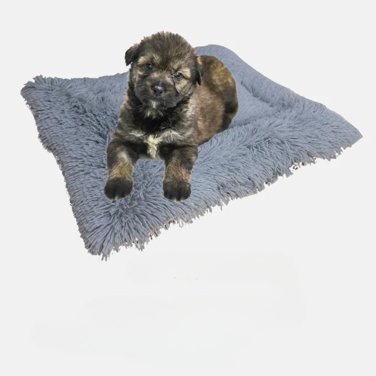 Two purpose gray pet blanket nest with long plush top and black non-slip bottom on a sofa