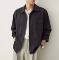 Men's light sand rice coloured cotton shirt with lapel collar and long sleeves laid flat.