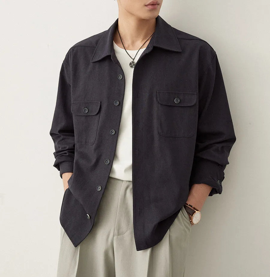 Men's light sand rice coloured cotton shirt with lapel collar and long sleeves laid flat.