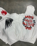 Black loose hooded sweatshirt with skull print and rhinestone design on model