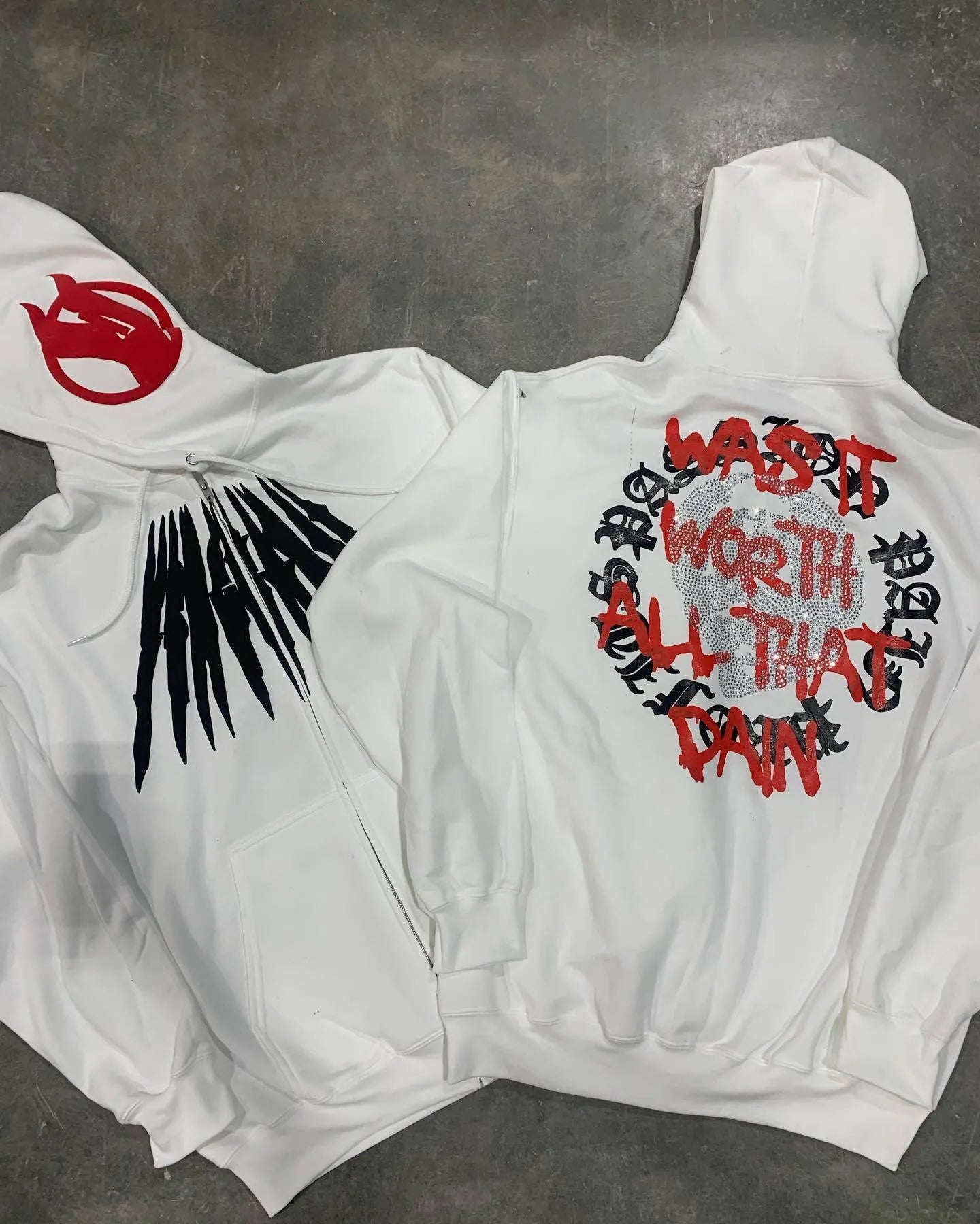 Black loose hooded sweatshirt with skull print and rhinestone design on model