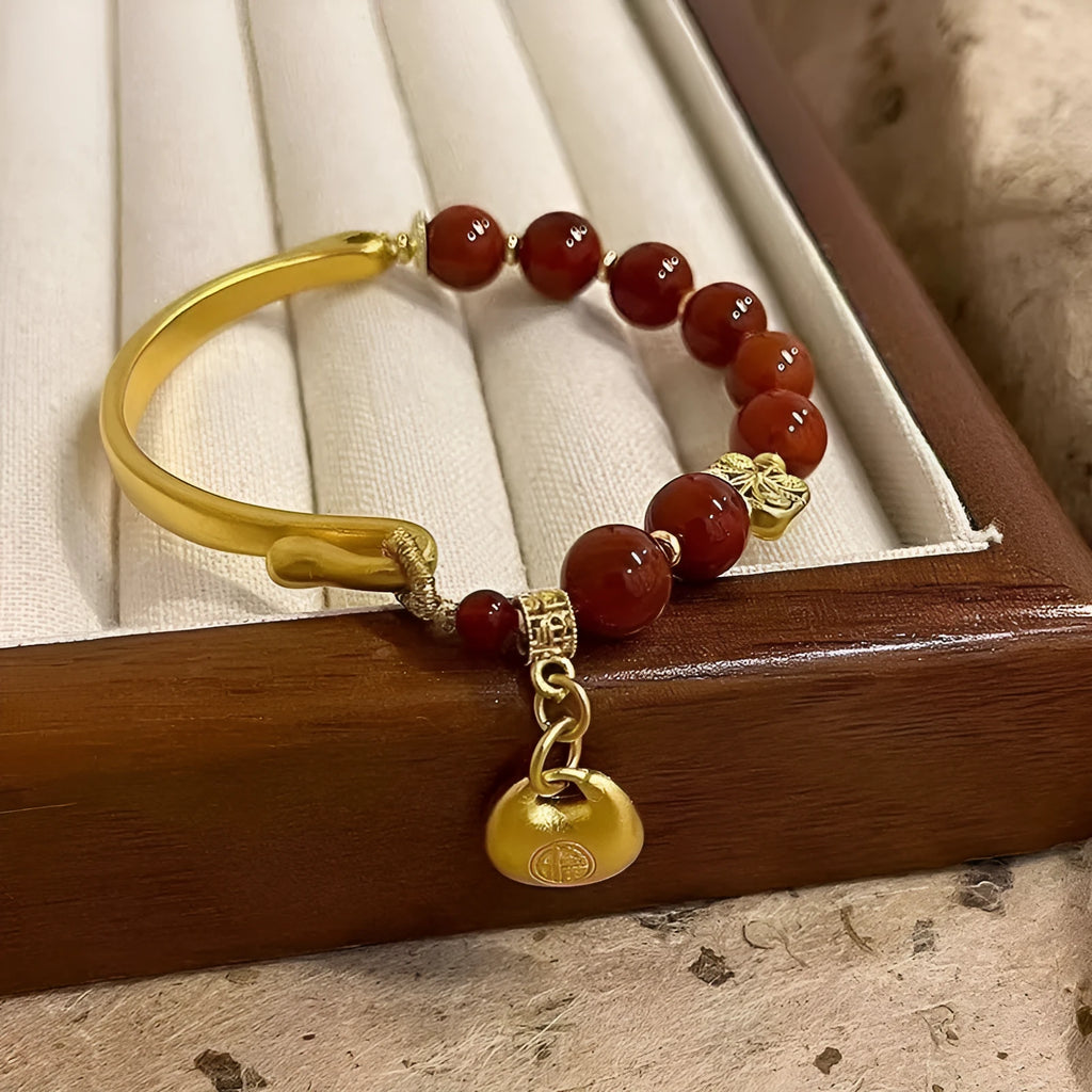 Golden South Red Agate Character Ingot Bracelet with lucky bag charm on a white background