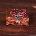 Handmade bracelet with geometric watermelon crystal beads and Chinese knotting in 6mm or 8mm size.