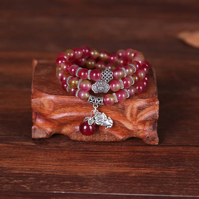 Handmade bracelet with geometric watermelon crystal beads and Chinese knotting in 6mm or 8mm size.