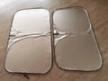 Aluminium foil car windscreen sunshade in silver, showing reflective surface.