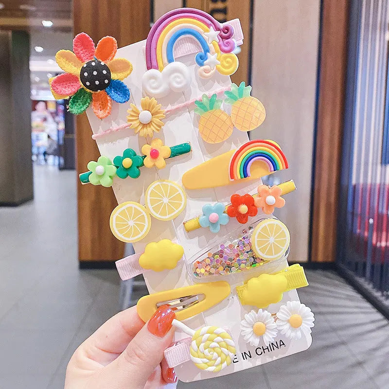 14-piece toddler hair accessories set on display including rainbow barrettes, fruit clips, and butterfly pins in bright colours