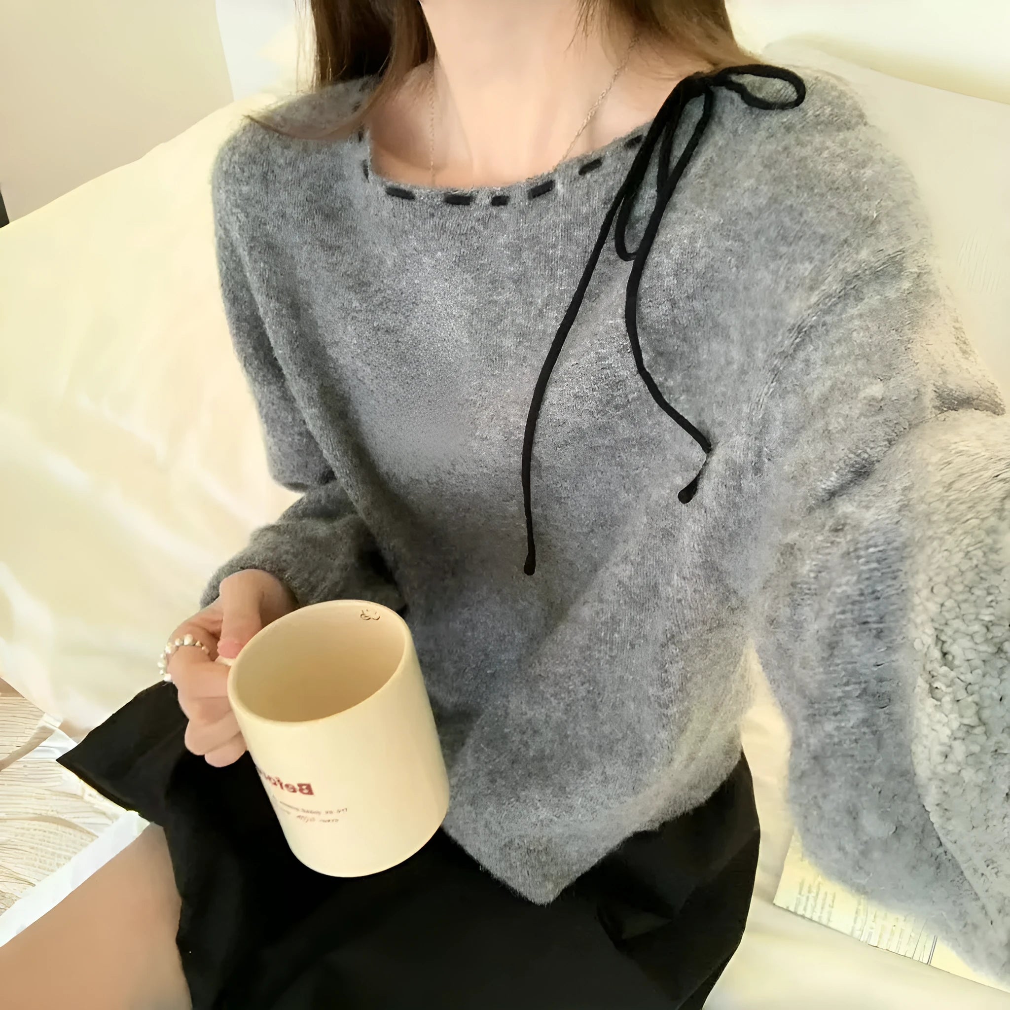Grey loose-fit women's pullover knitwear on a hanger