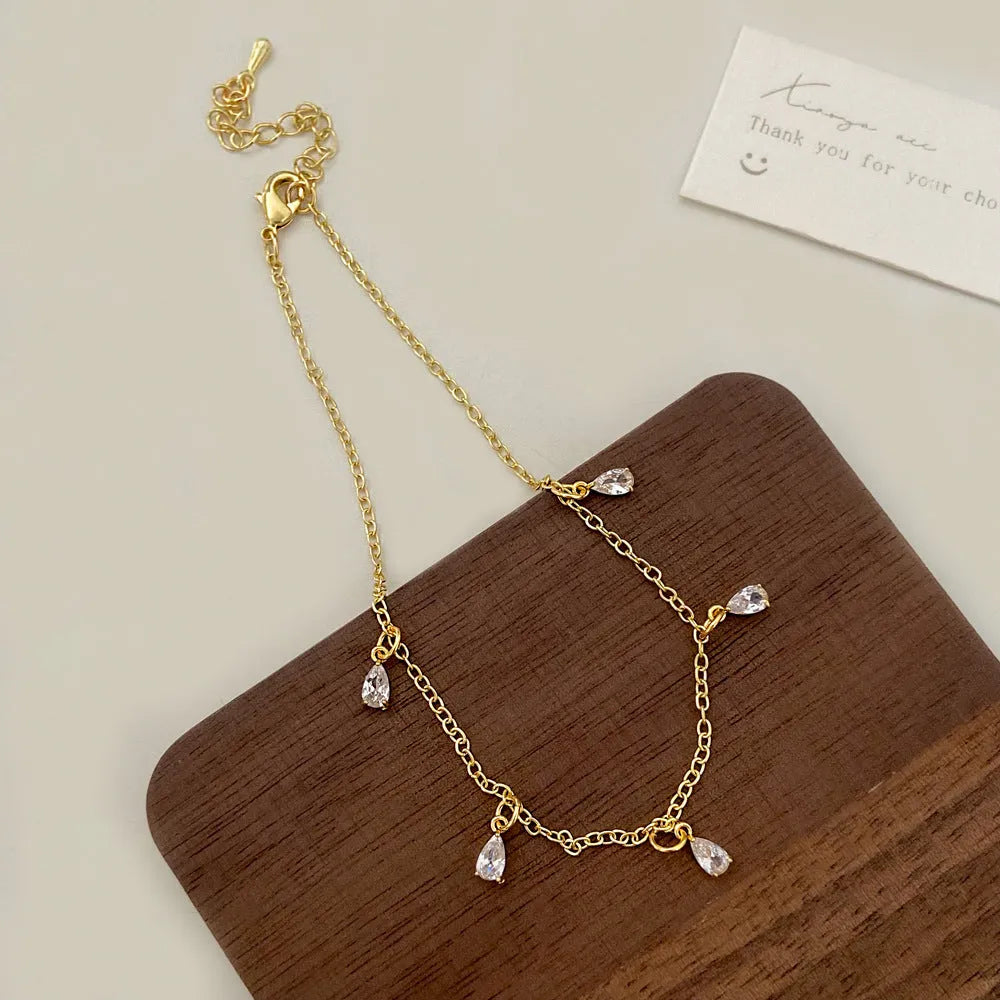 Women's zircon jewellery set with necklace, earrings and anklet in geometric meteor shower design