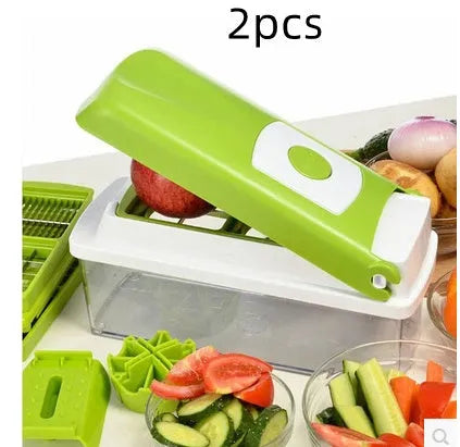 Green multifunctional vegetable chopper with handle, grater, and stainless steel blades on a chopping board