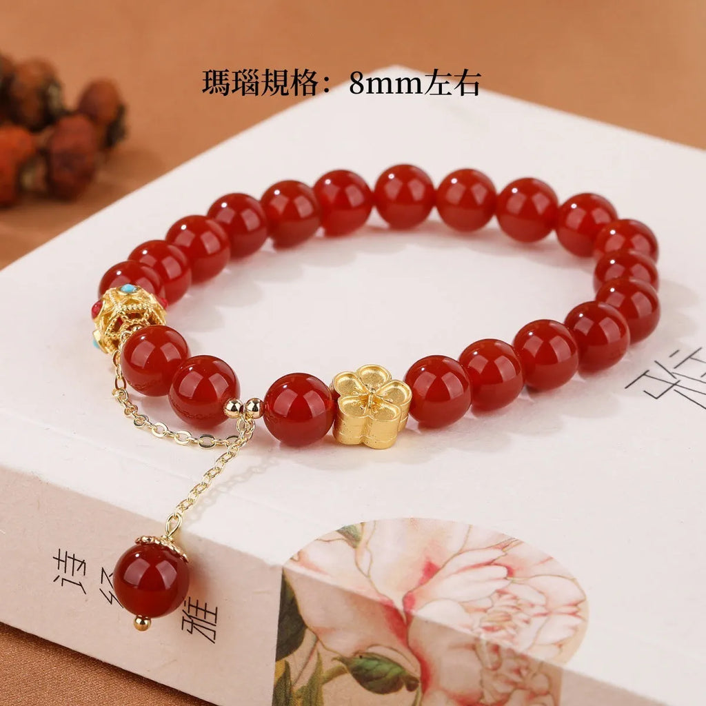Natural red agate bracelet with 8mm beads and copper peach blossom parts on wrist