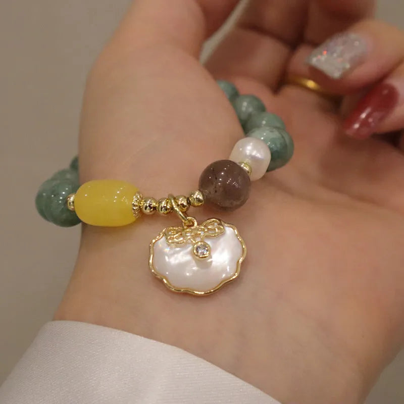 Natural green jade shell bracelet on a woman's wrist, casual style