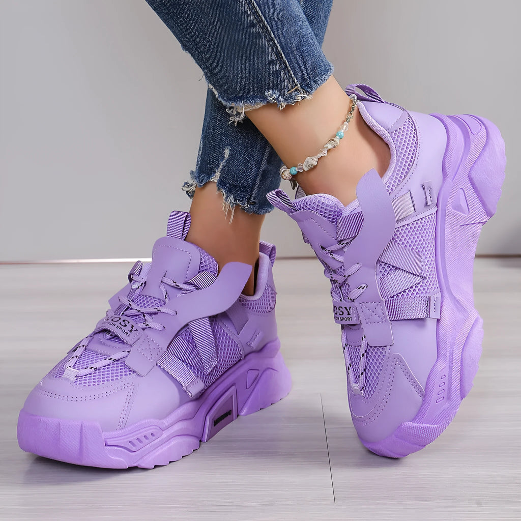 Women's purple platform mesh dad shoes with lace-up front, shown on a fitness floor.