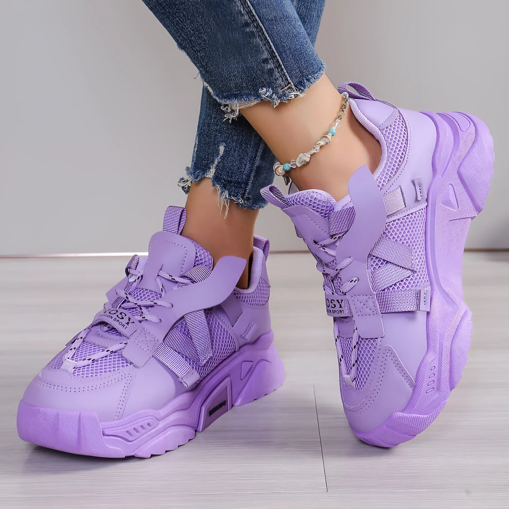 Women's purple platform mesh dad shoes with lace-up front, shown on a fitness floor.