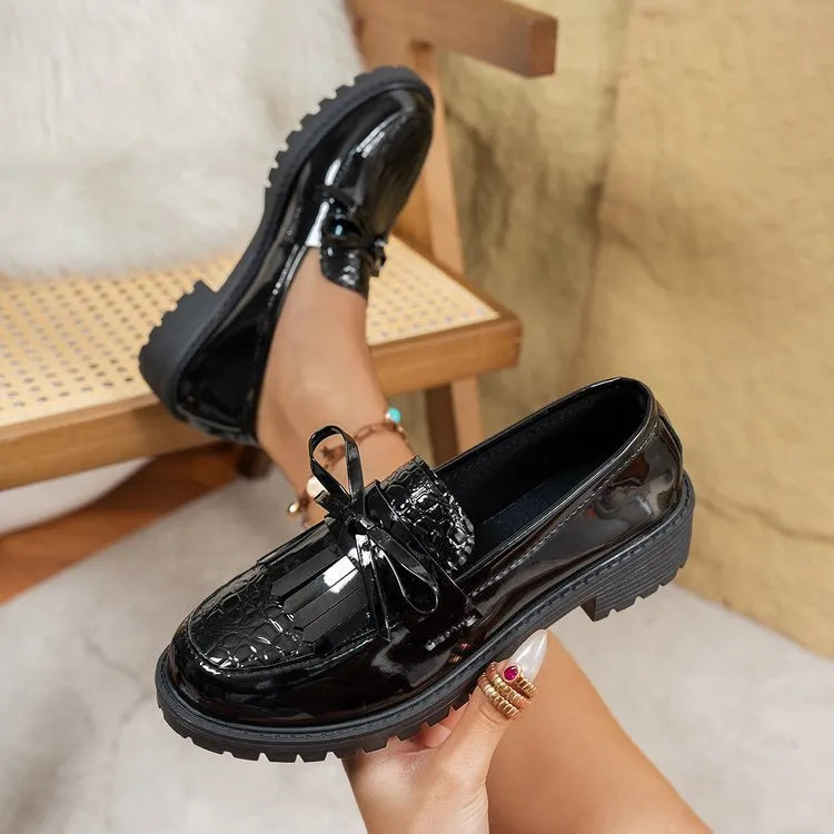 Women's brown loafer shoes with decorative bow detail on synthetic PU upper