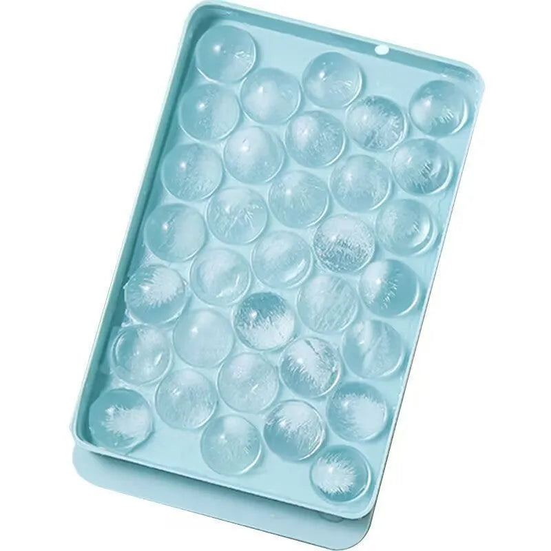 Blue silicone round ice cube tray with lid showing 33 grid design