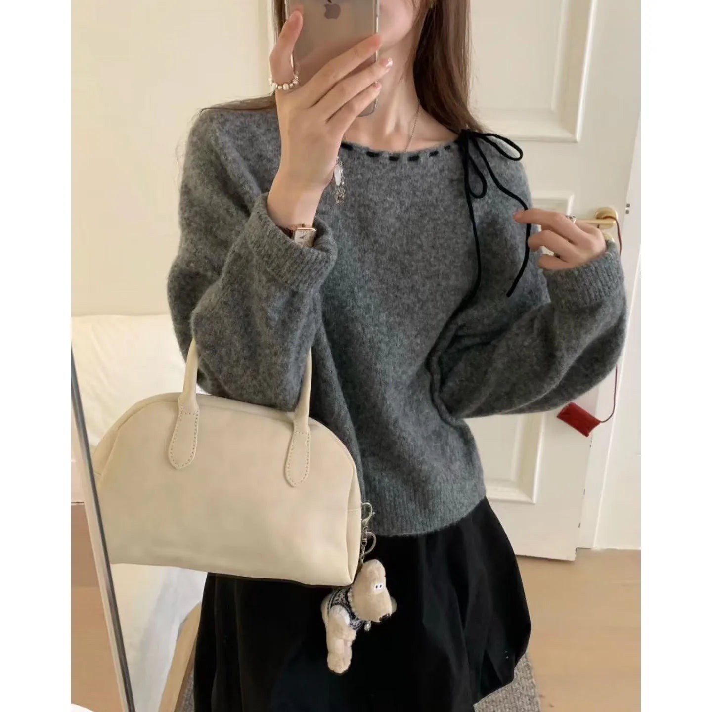 Grey loose-fit women's pullover knitwear on a hanger