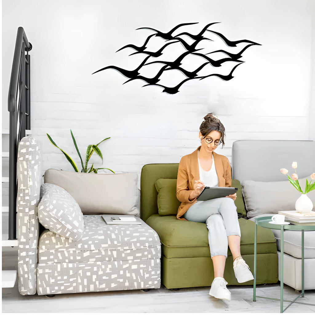 Metal flying bird wall decoration with seagull finish on a white wall