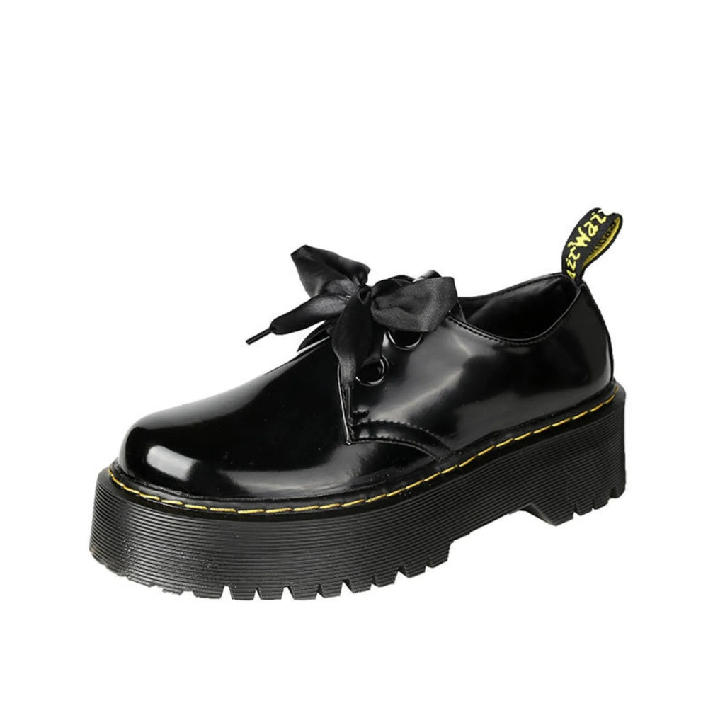 Women's black thick-soled leather shoes with cross strap design and lace-up closure