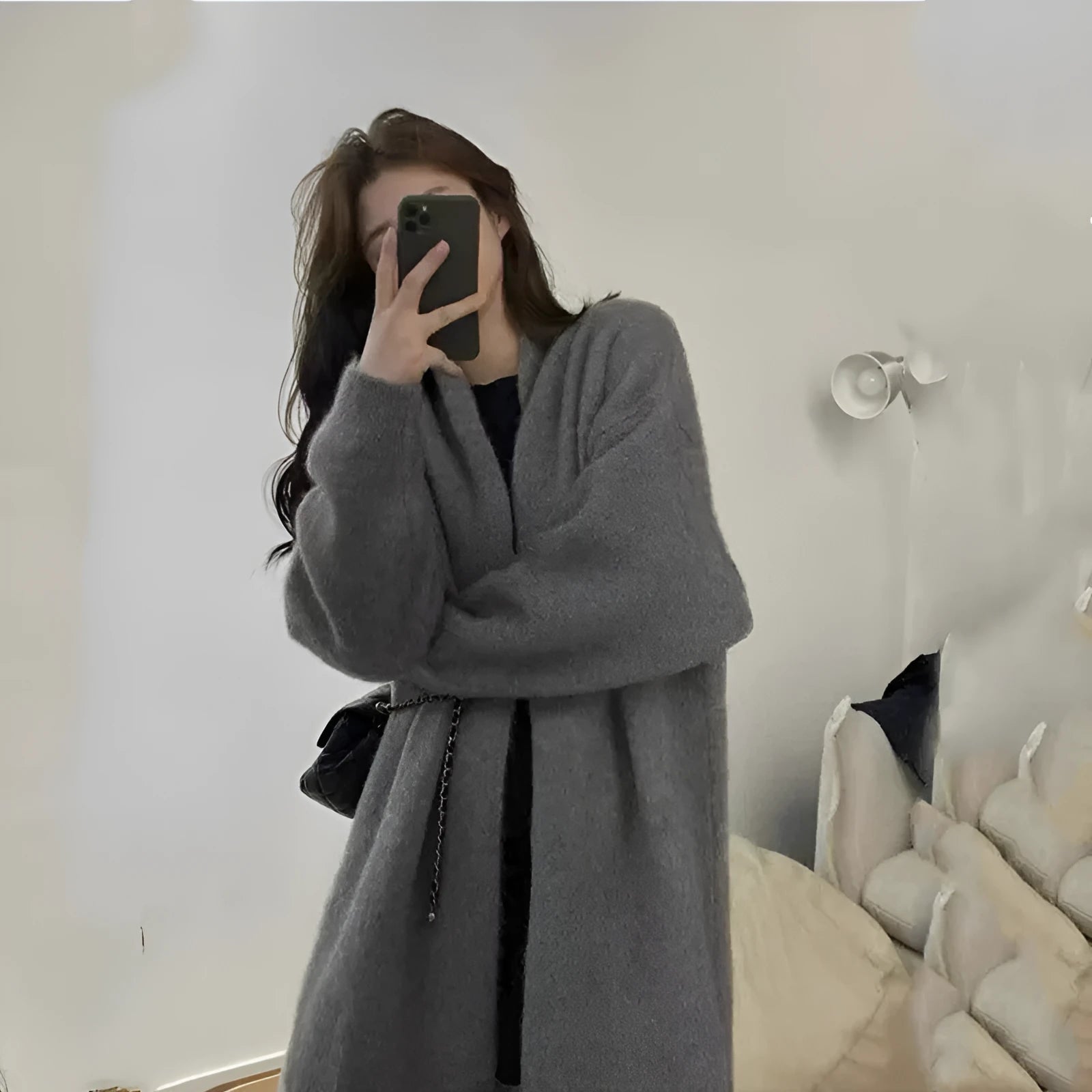 Loose fit women's knitted cardigan sweater in thick chenille fabric, medium length.