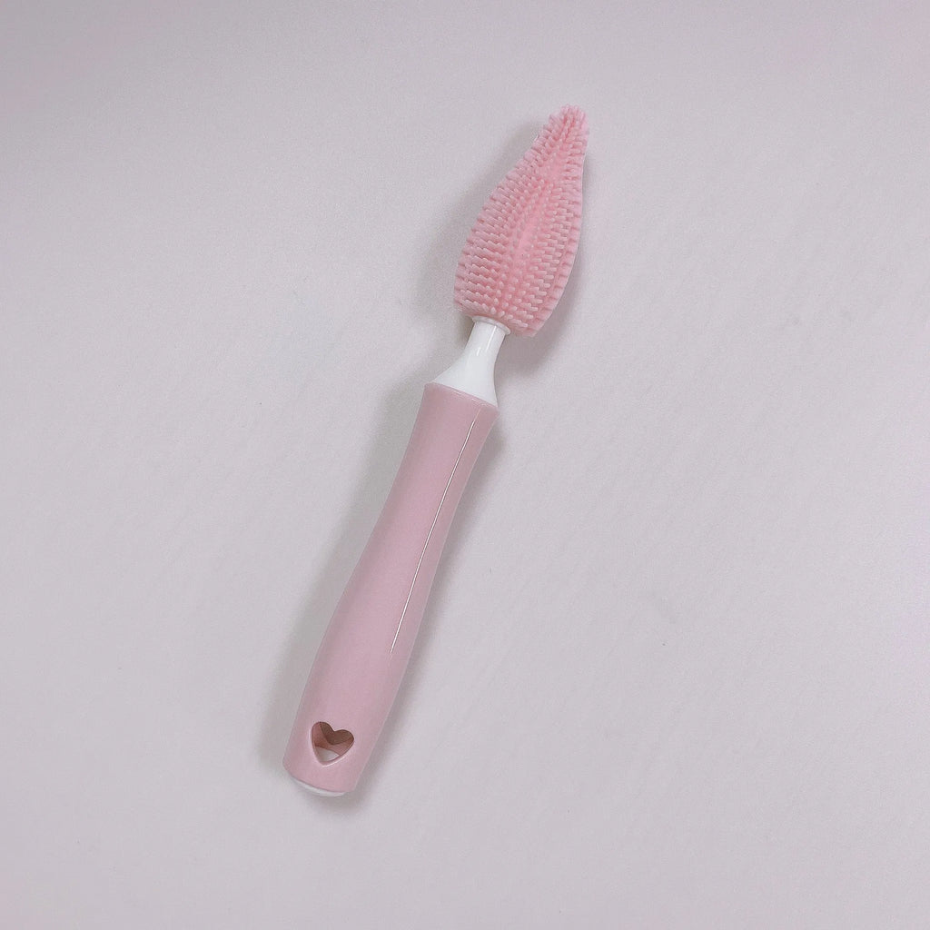 Three-piece silicone baby bottle brush set in pink, blue, and yellow with straw cleaning tool
