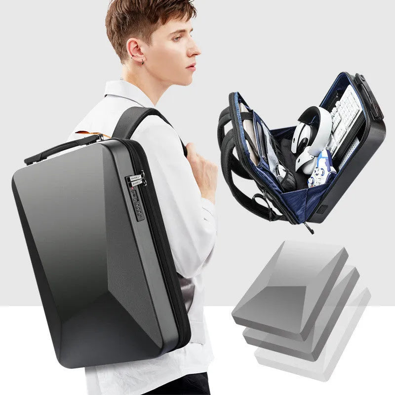 Large grey hard-shell gaming backpack with dual straps, showing lock and internal organiser pockets for computer and phone.