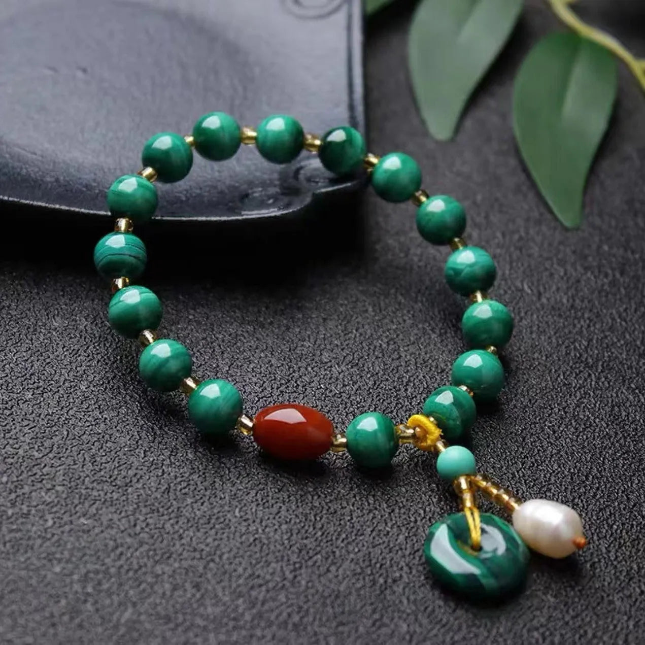 Natural green malachite and red agate barrel bead bracelet measuring 7-8mm with handcrafted unisex design