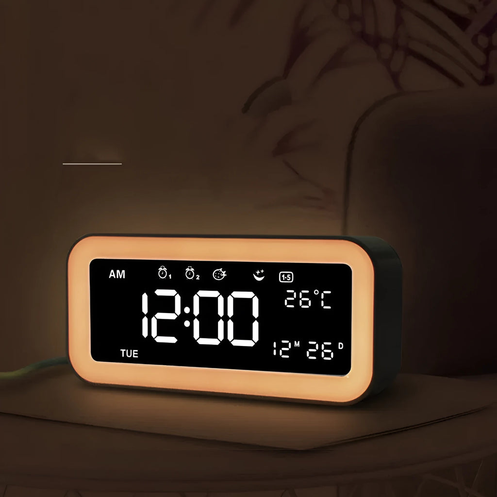 Blue rectangular LED atmosphere light alarm clock with digital display on a wooden desk.