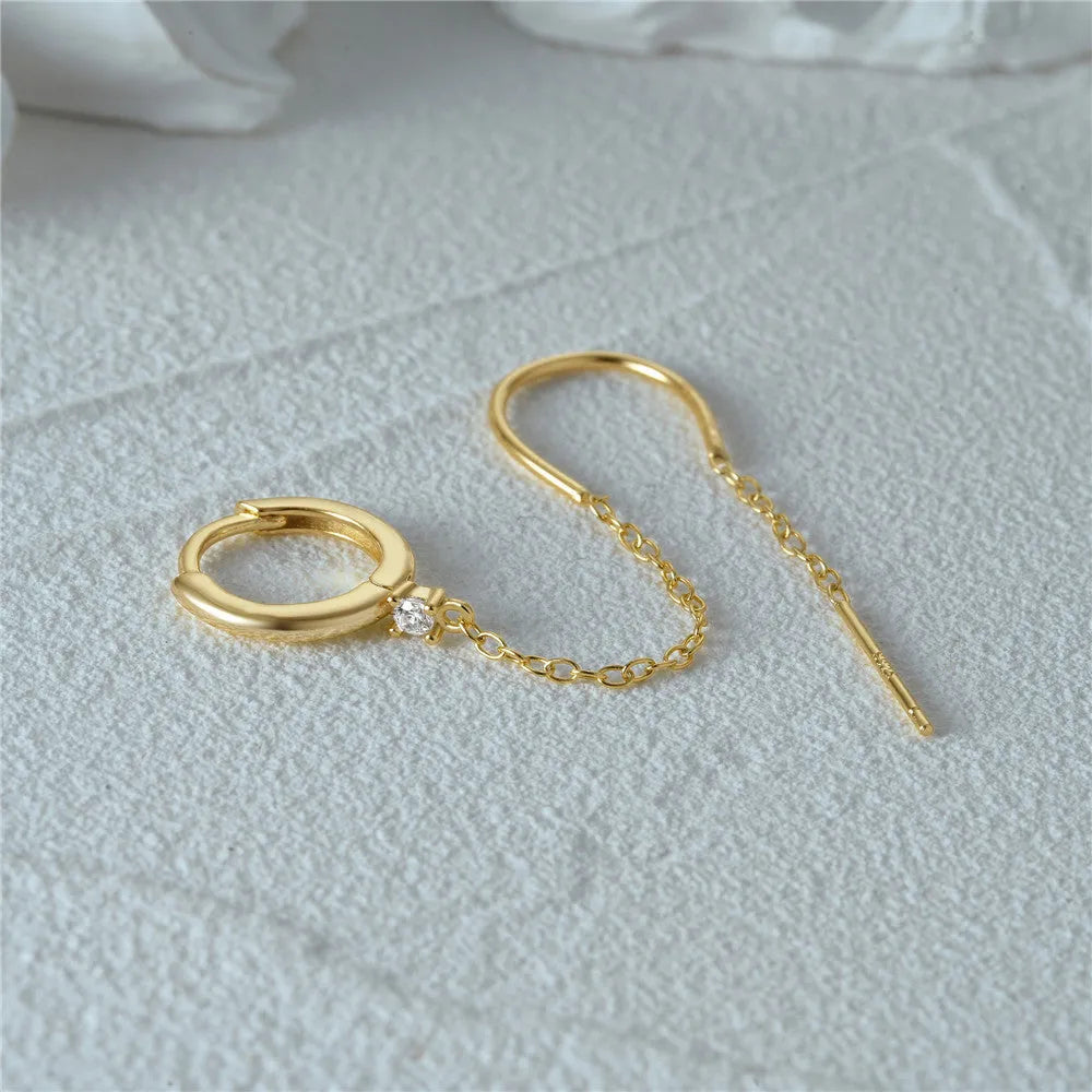 Golden tone sterling silver ear clip studs with a geometric flower, tassel, and chain design.
