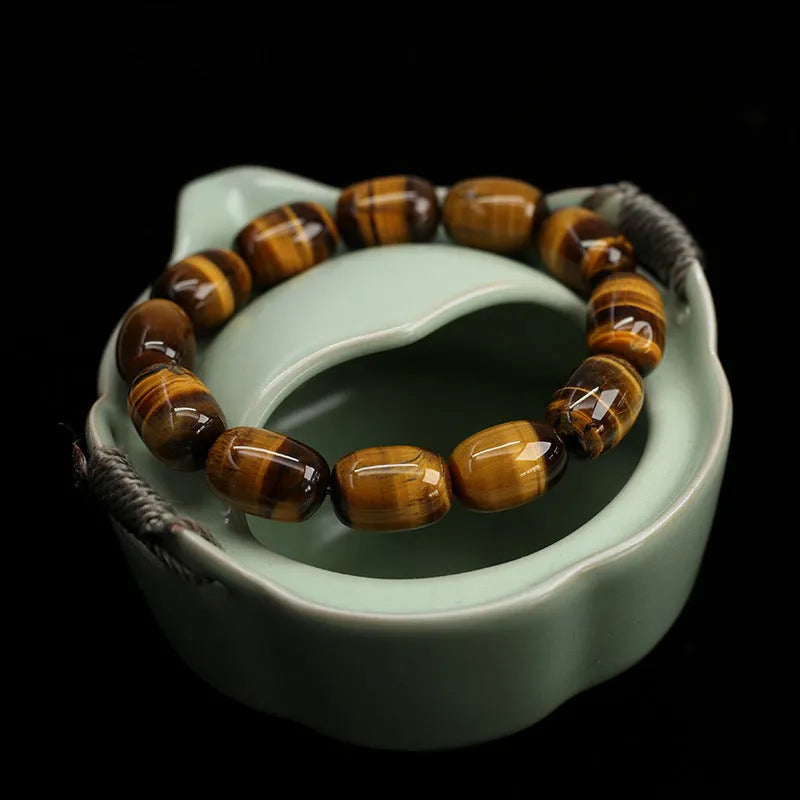 Natural yellow tigereye bracelet with cat eye sheen, 11x16mm beads, unisex constellation style on white background