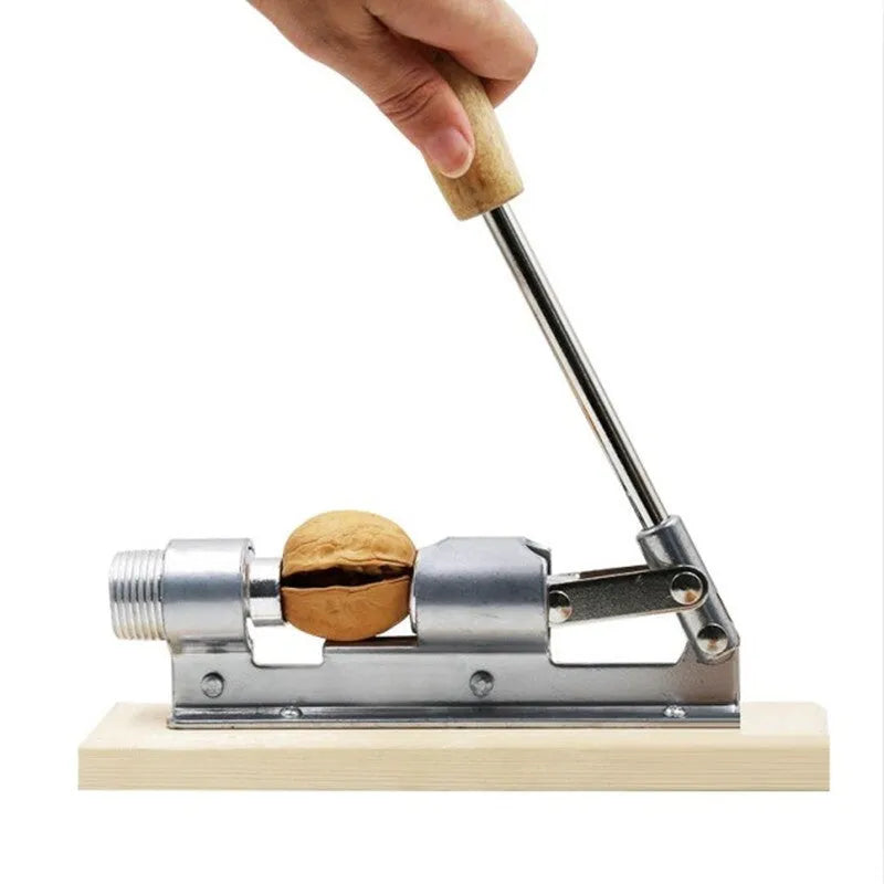 Mechanical walnut cracker with wood body and aluminium mechanism on a table
