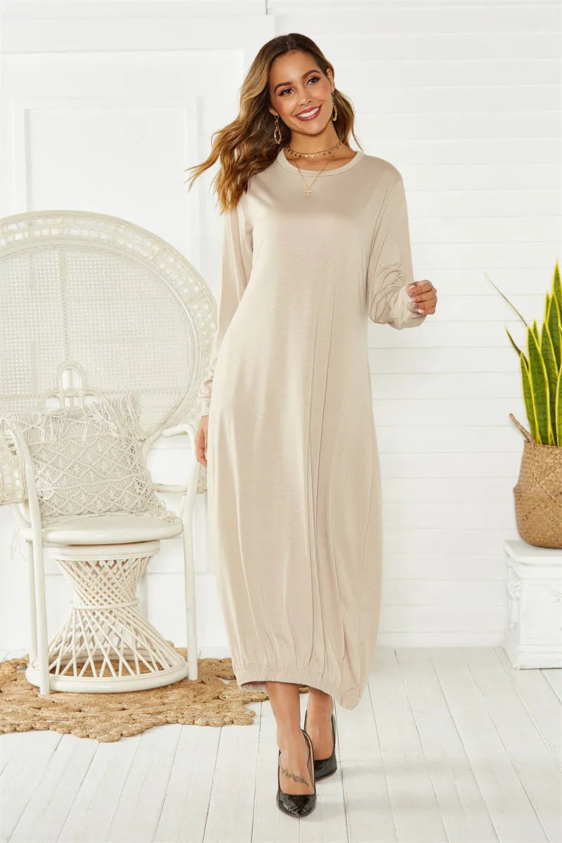 Black lantern dress with lace-up crew neck and loose long silhouette on a hanger.
