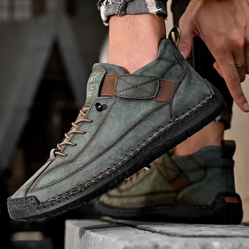 Men's mid-calf Martin boots in khaki with tooling stitching and an elastic band closure.
