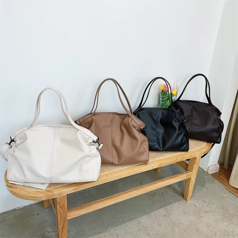 Large soft surface messenger bag with zip opening and adjustable shoulder strap in four colour options