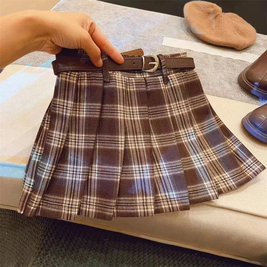 Girls red and black plaid pleated A-line skirt made from cotton blend fabric.