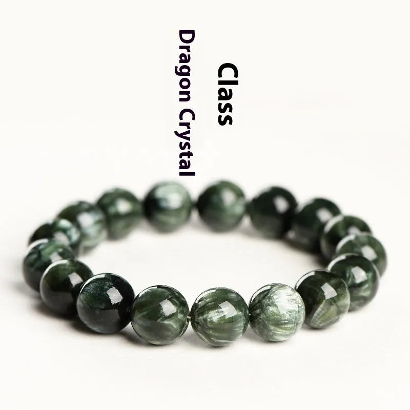 Natural green dragon crystal round bead bracelet with ruyi design on a wrist.