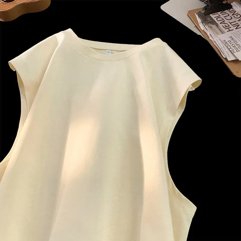 Men's loose sleeveless cotton t-shirt in a solid colour on a hanger.