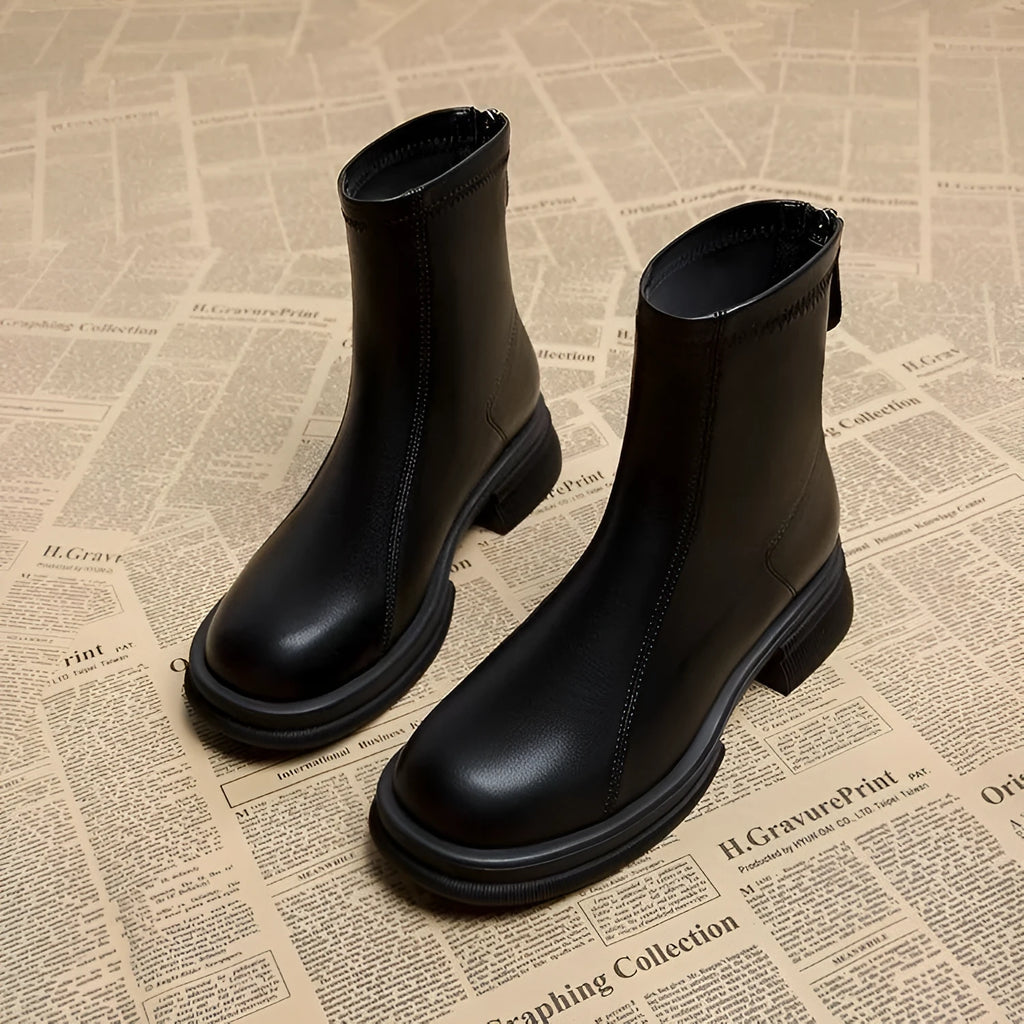 Women's black ankle boots with thick flat heel and back zipper, round toe design