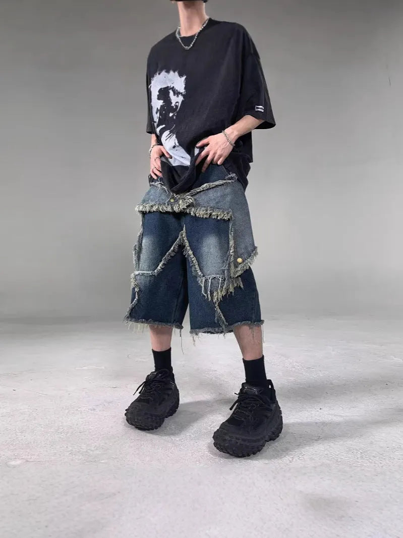Blue denim shorts with five-pointed star embroidery and frayed edges, loose fit silhouette