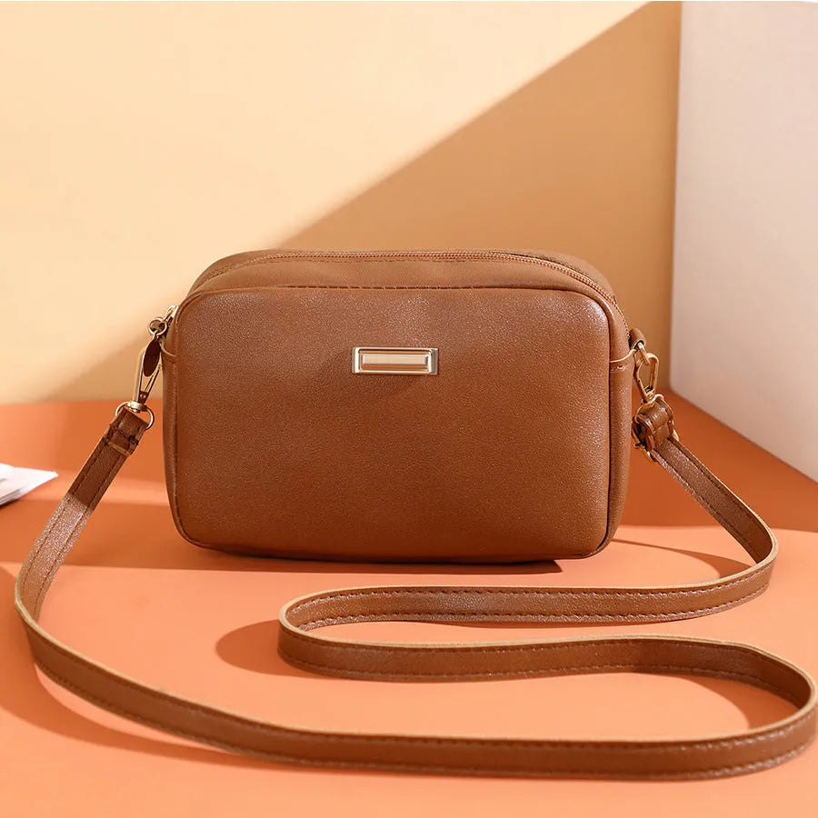 Women's square shoulder bag in PU material with a 3D front pocket, shown in a solid colour.