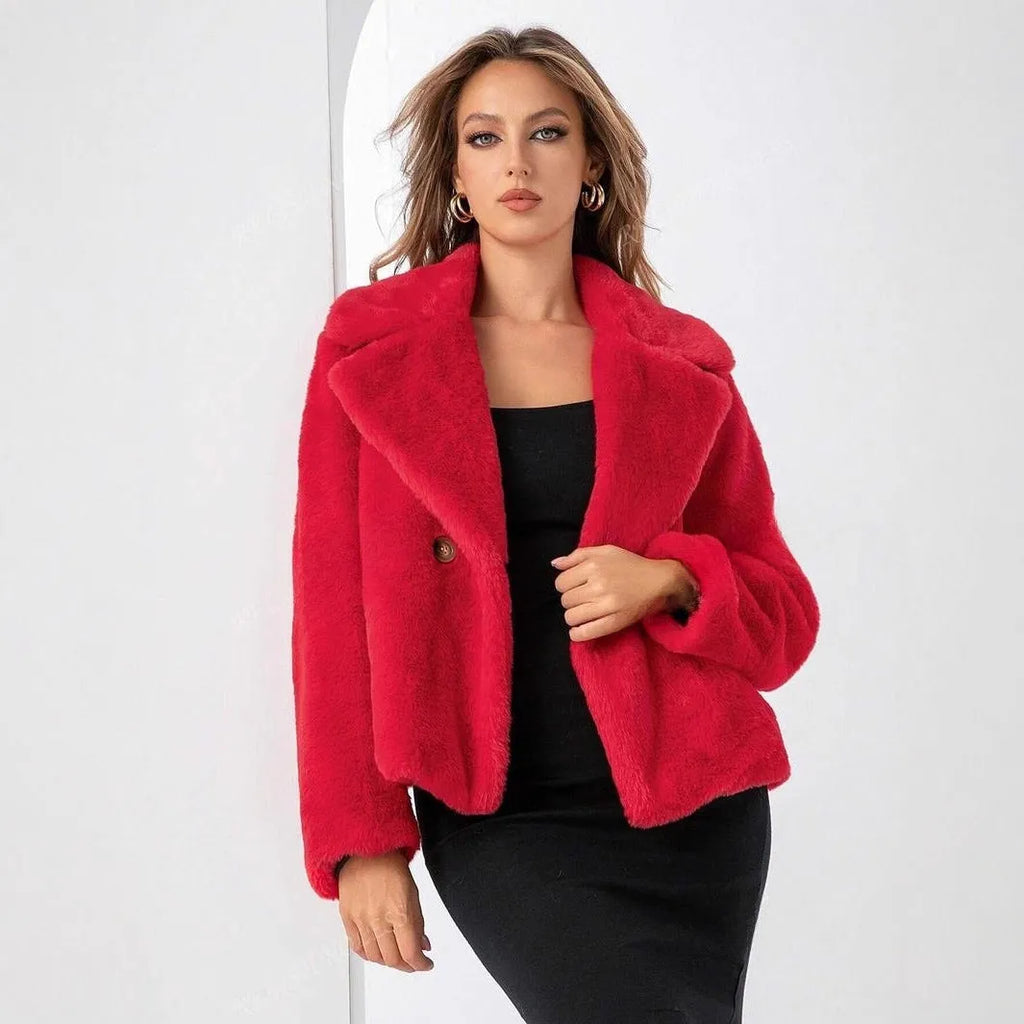 A rose red women's short loose faux fur coat with regular sleeves on a model.