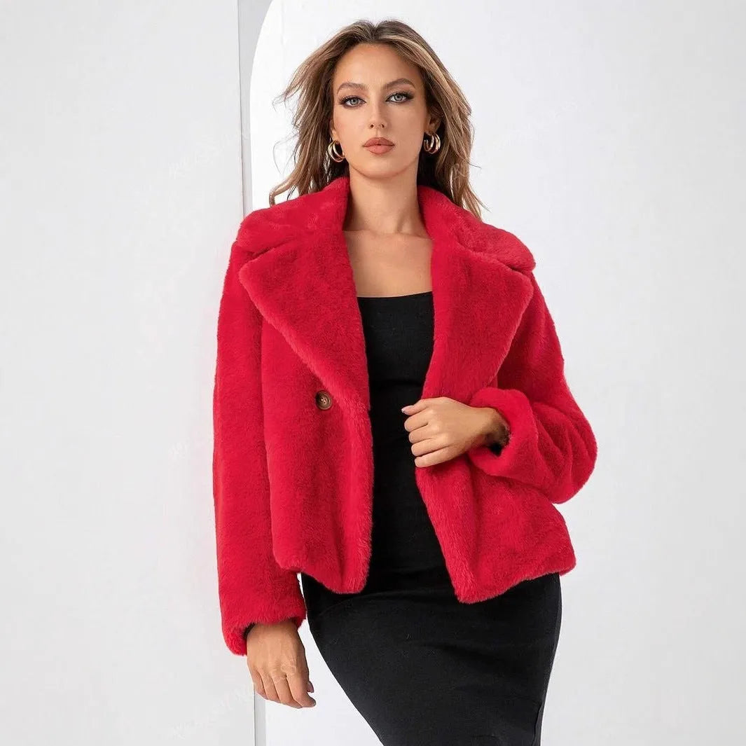 A rose red women's short loose faux fur coat with regular sleeves on a model.